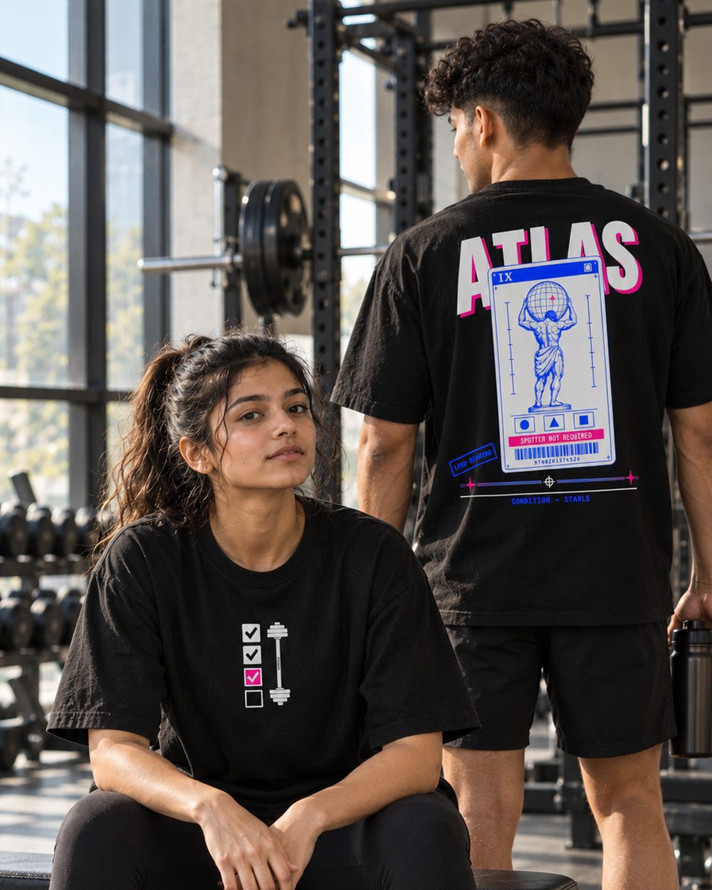 Two people in Atlas tees at a bench, back print and chest print