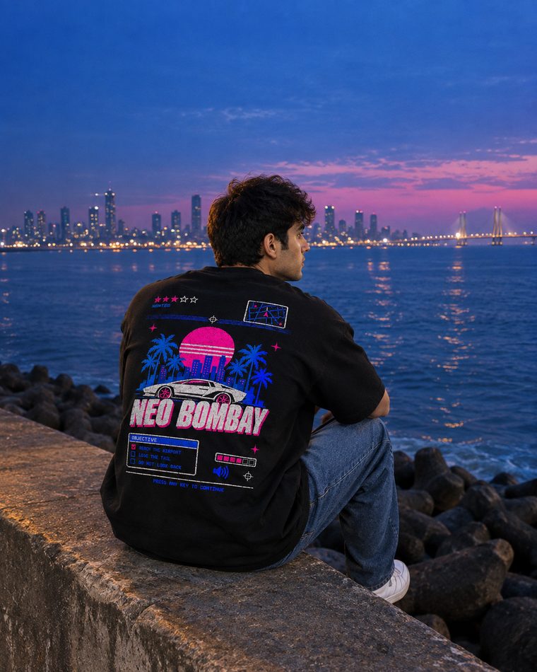 Neo Bombay tee worn seated by the sea wall