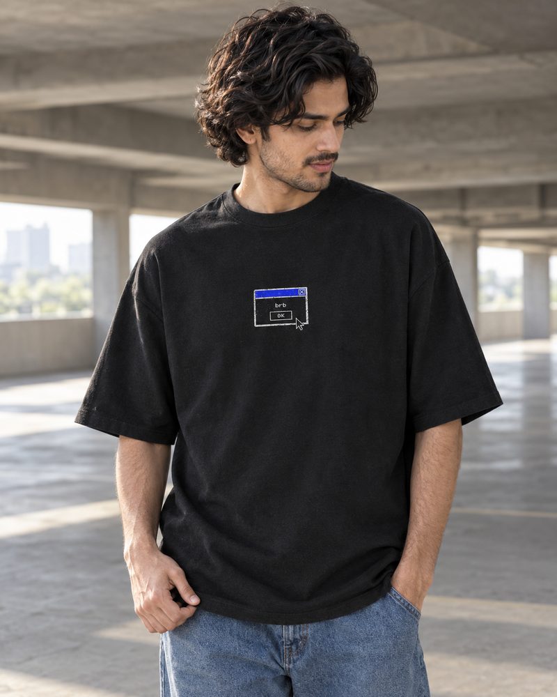 Not Responding tee, small brb dialog-box chest print, in an open parking structure